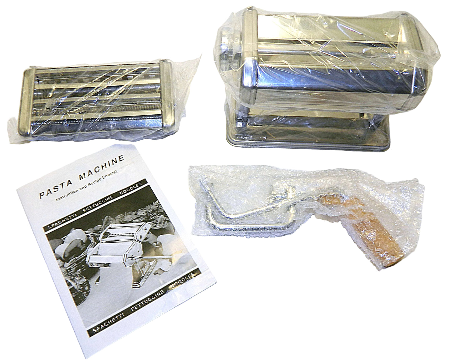 Pasta machine with packaging and a manual on a white background