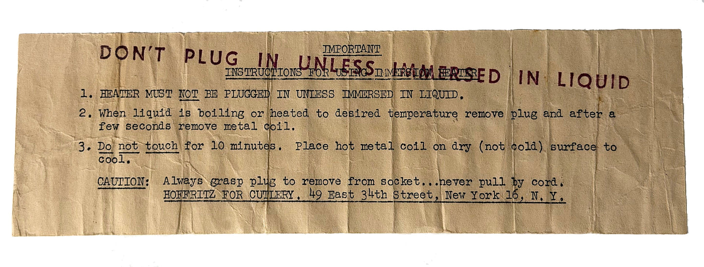 A vintage paper instruction sheet with stamped red text and handwritten blue ink notes, detailing how to properly plug and immerse a heating coil in liquid.