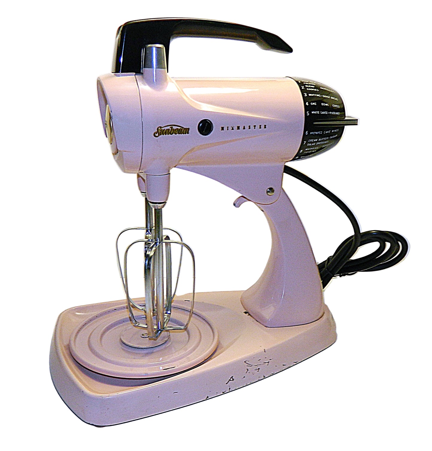 Vintage pink stand mixer with whisk attachment on a white background