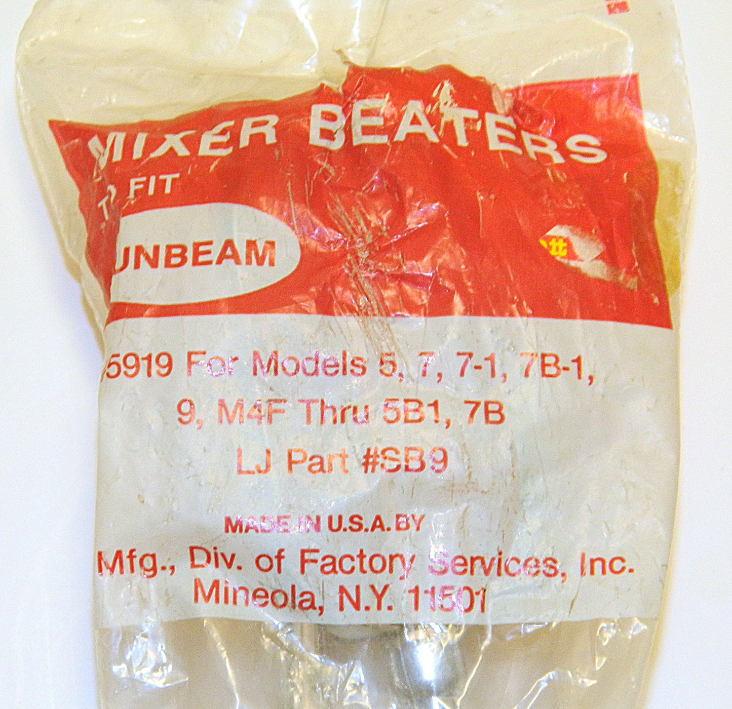 Packaged mixer beaters with Sunbeam branding and product details on a white background