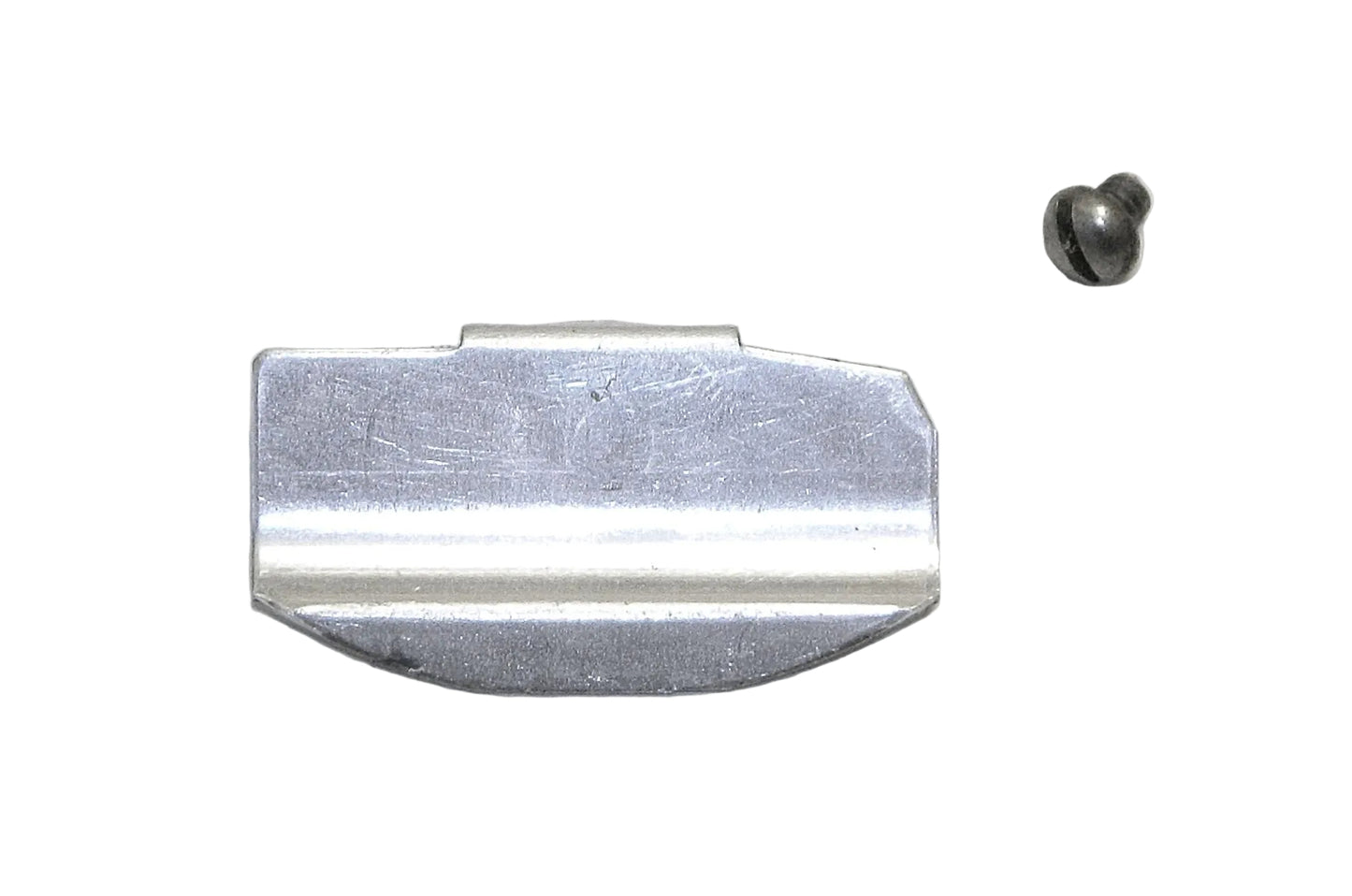 Metallic object resembling a razor blade on a gray background