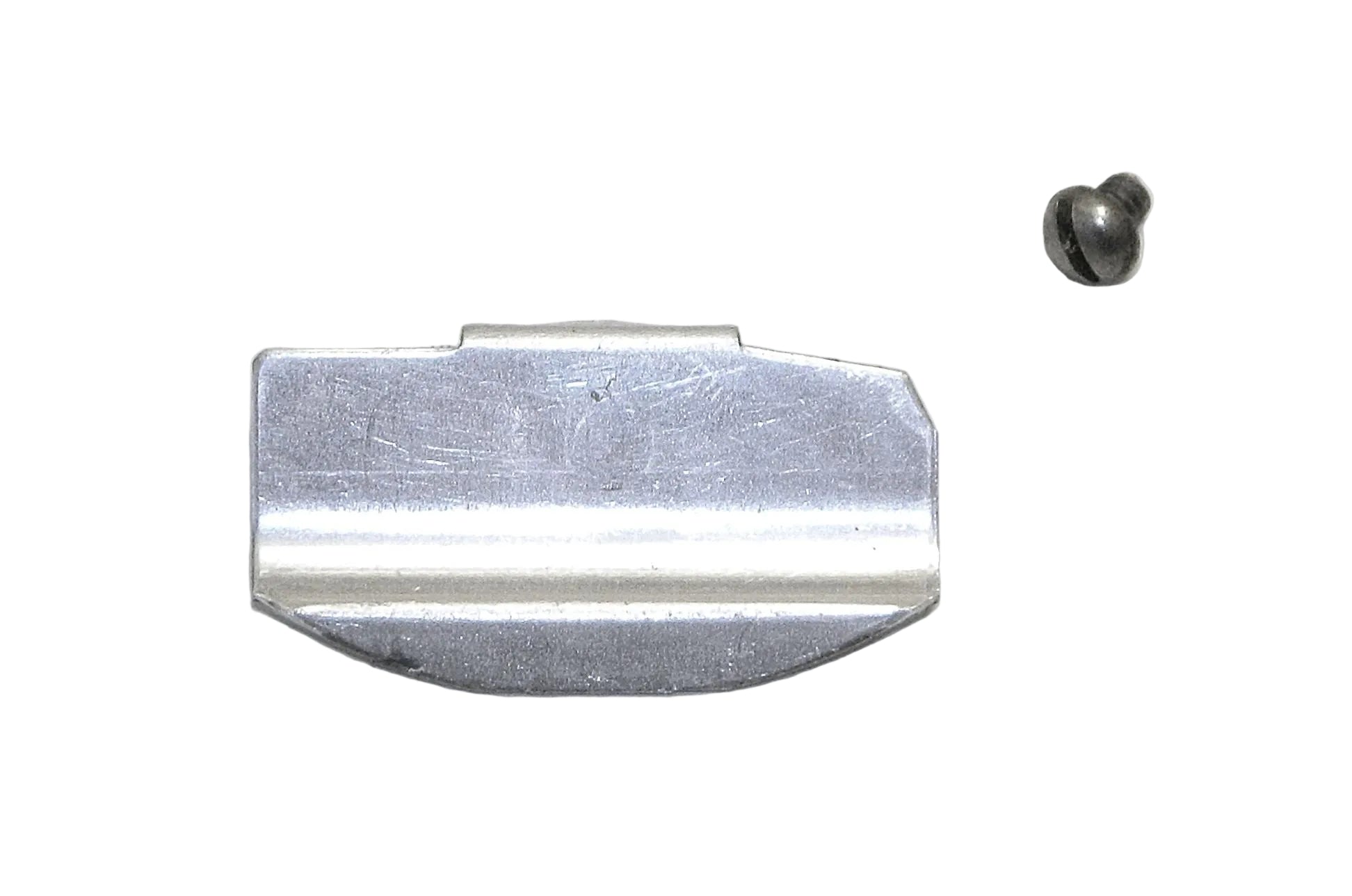 Metallic object resembling a razor blade on a gray background