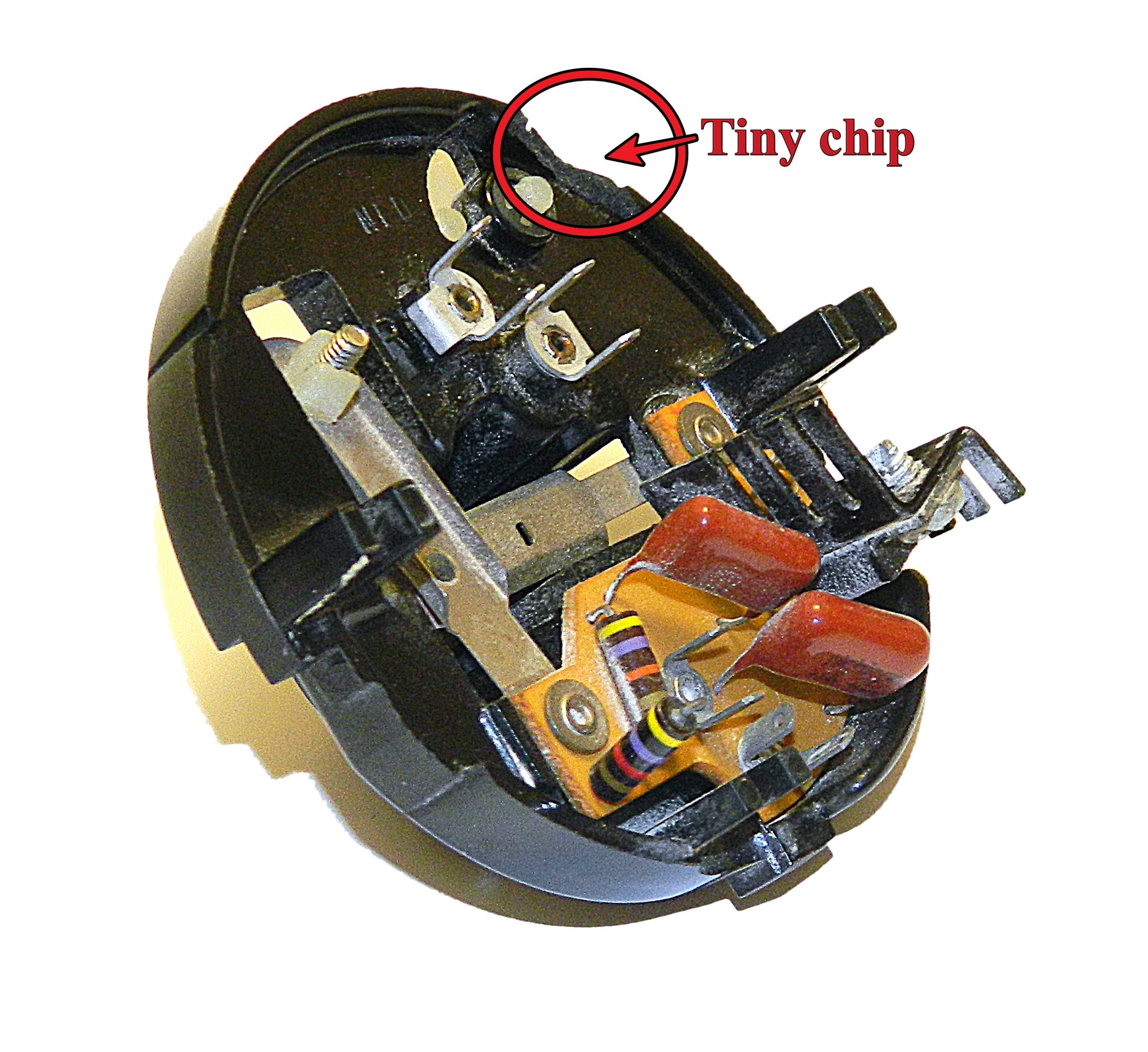 Close-up of a mechanical component with a tiny chip highlighted, on a white background.
