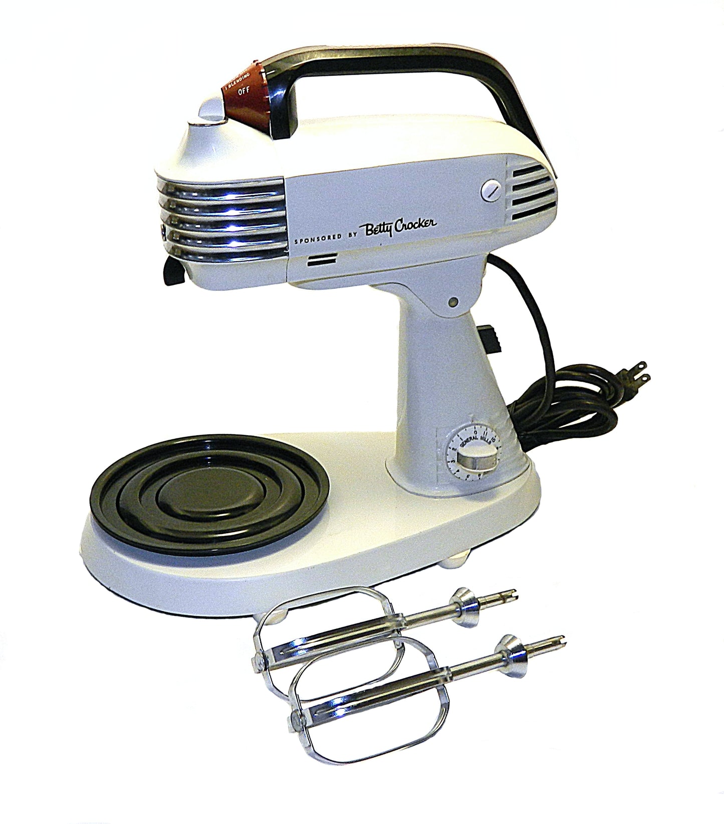 Vintage-style hand mixer with attachments on a white background