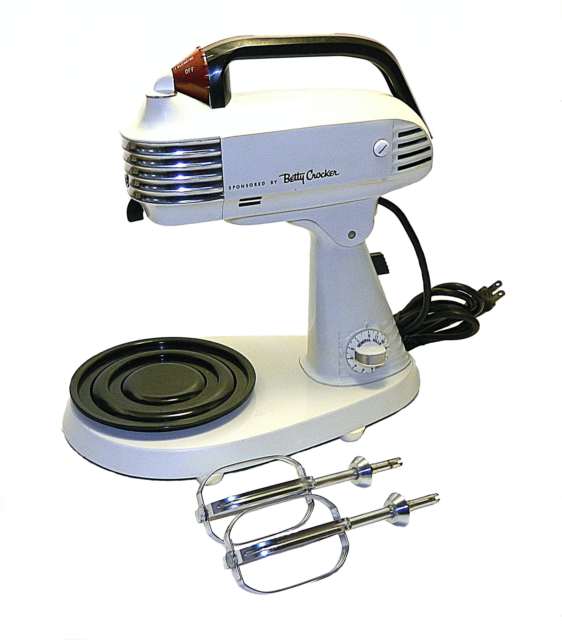Vintage-style hand mixer with attachments on a white background