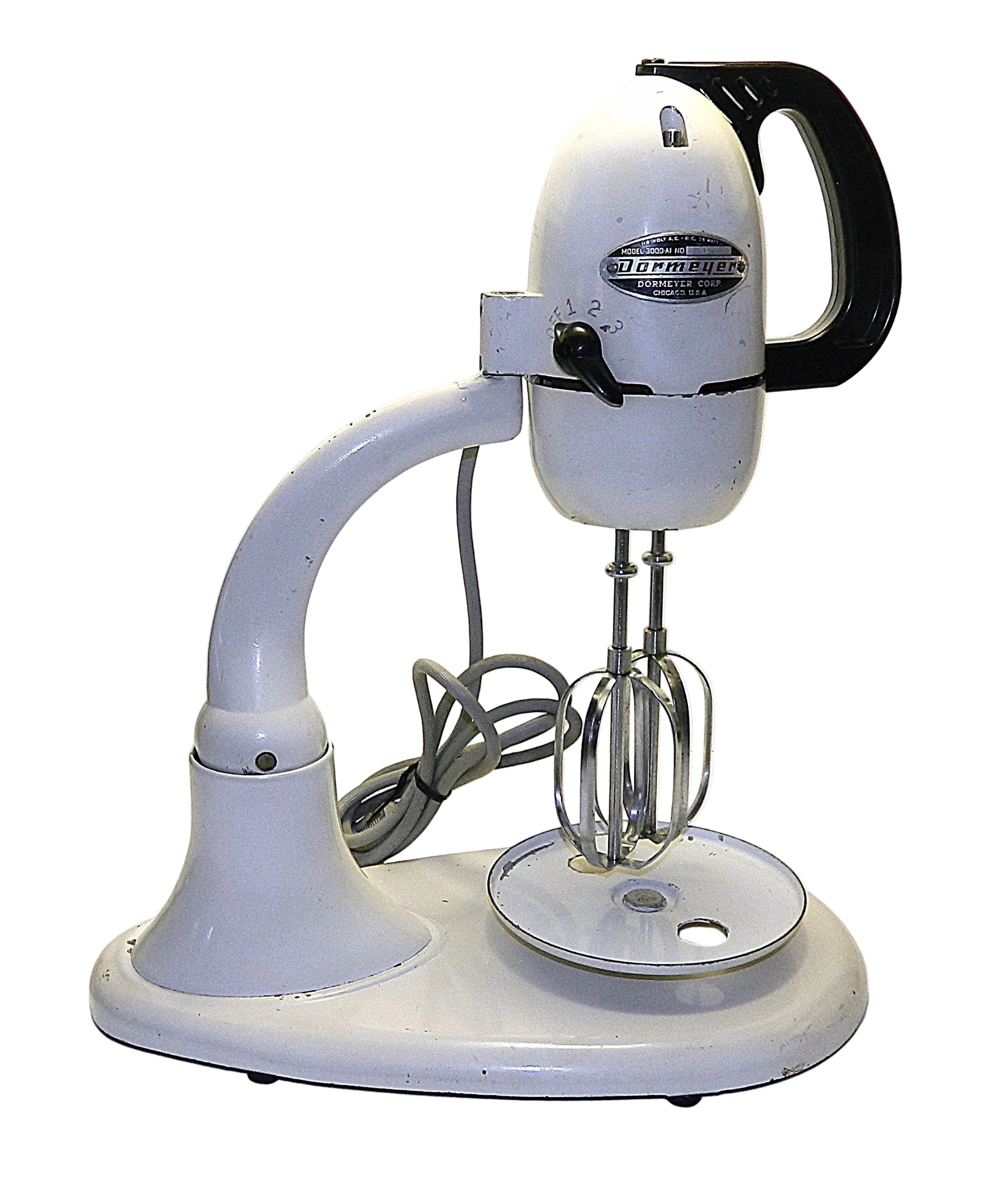 Vintage stand mixer with a white body and black handle on a white background