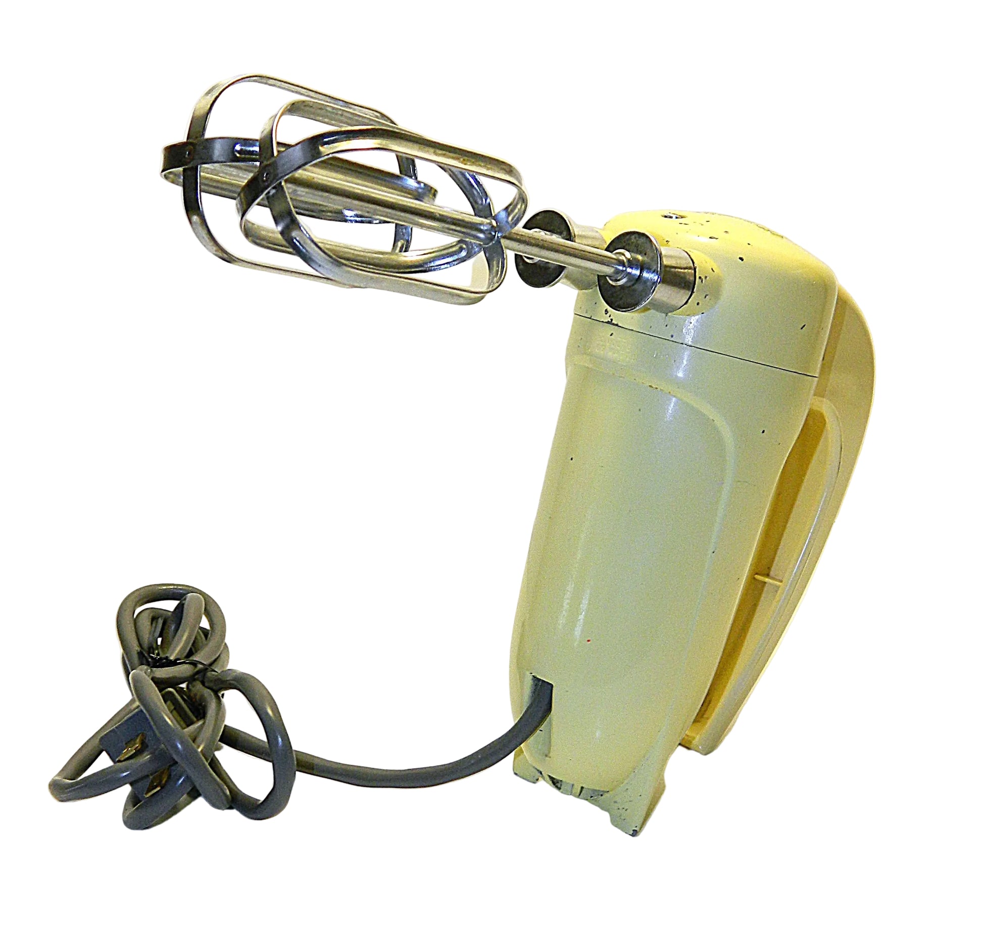Vintage yellow hand mixer with beaters on a white background