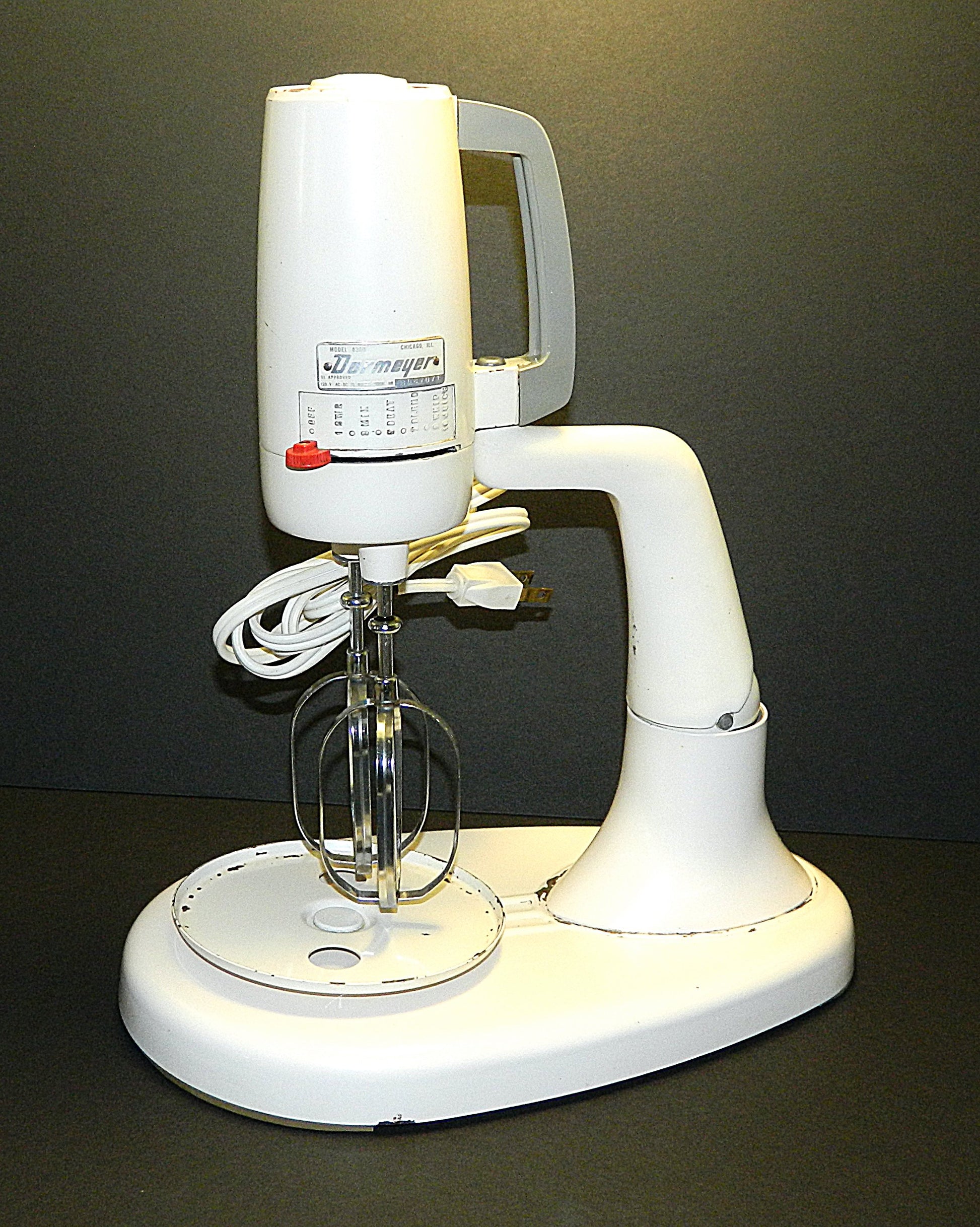 White stand mixer on a dark background