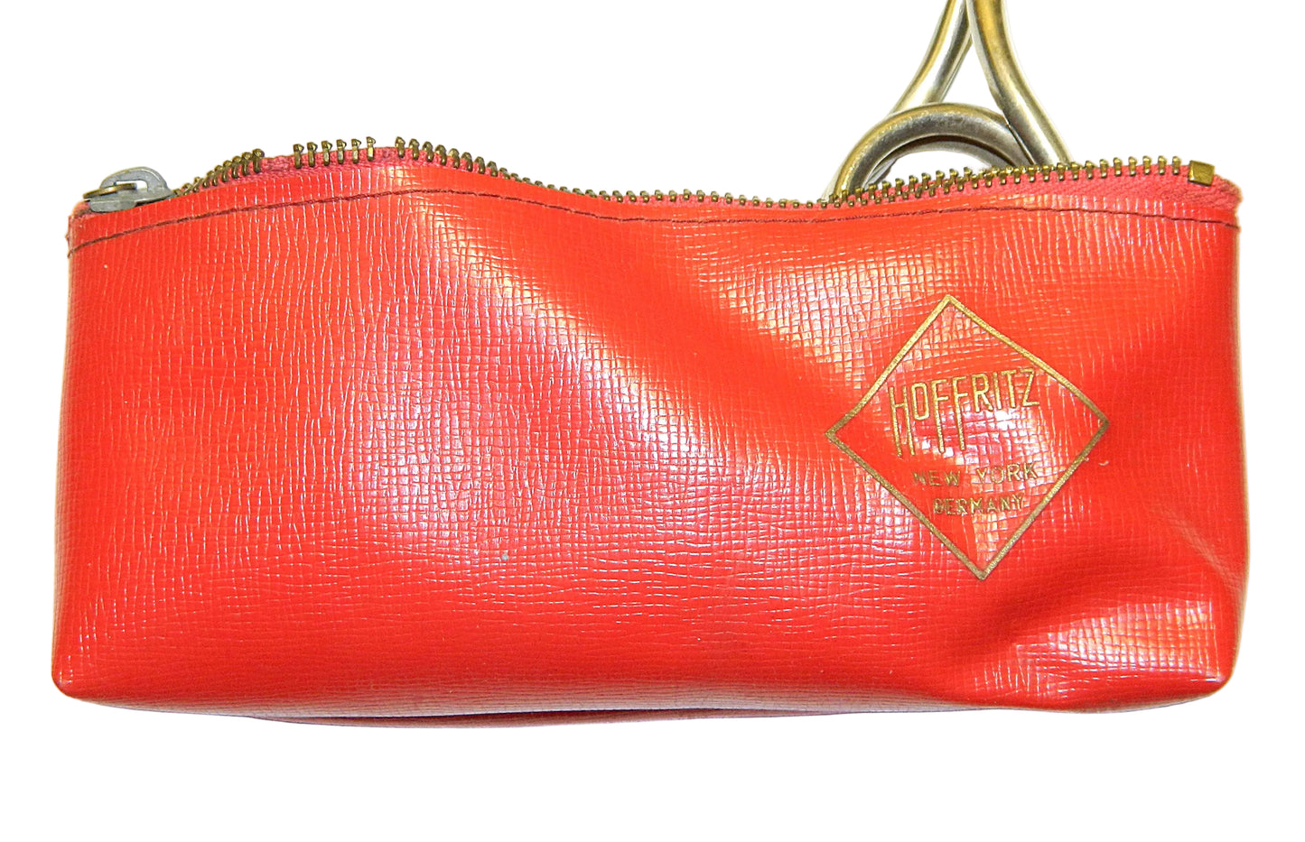 A red textured leather pouch with a gold-tone zipper and a diamond-shaped gold logo patch on the front that reads 'HOFFRITZ'.