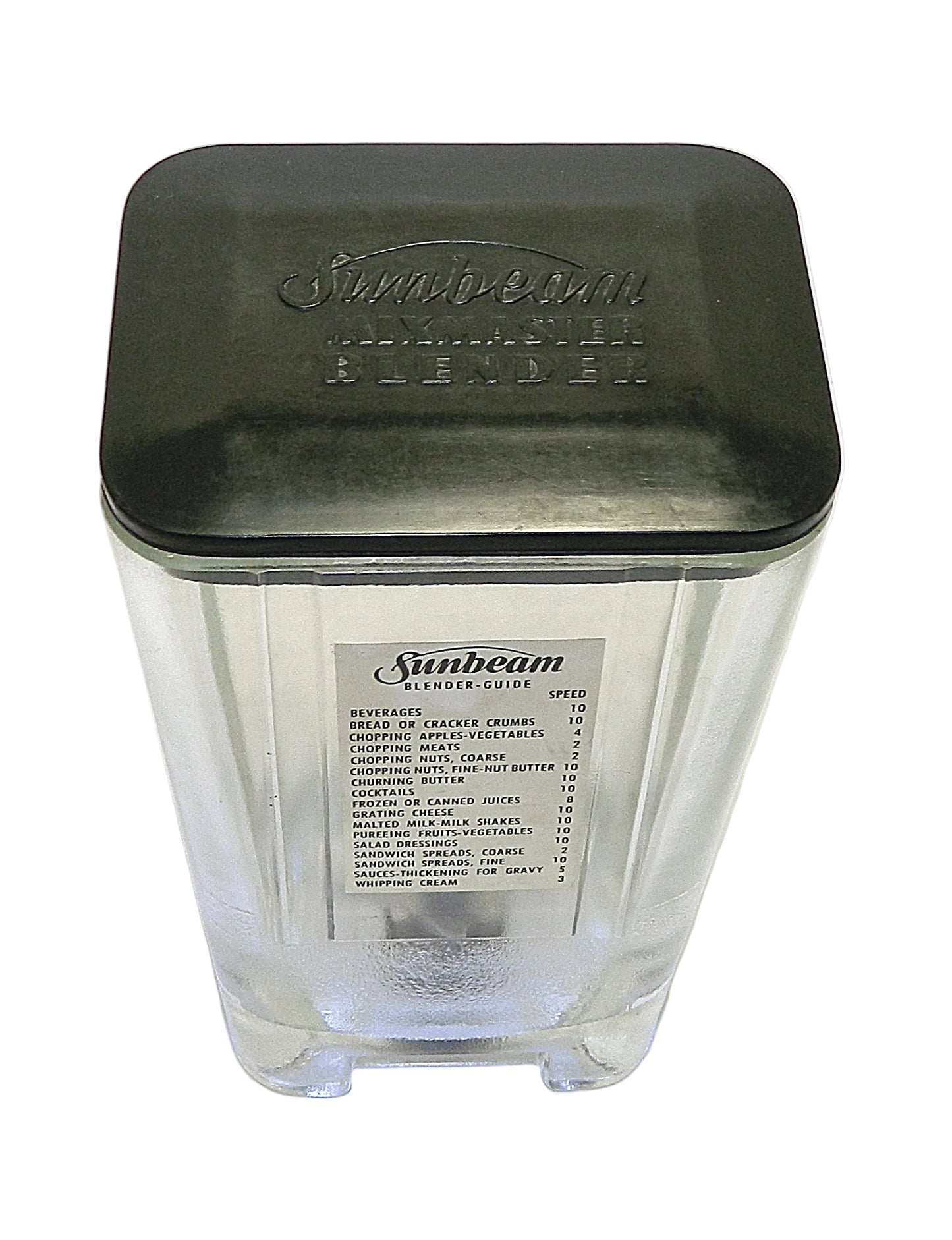A vintage Sunbeam blender jar with a clear glass body, a black plastic lid, and a white paper label on the front.