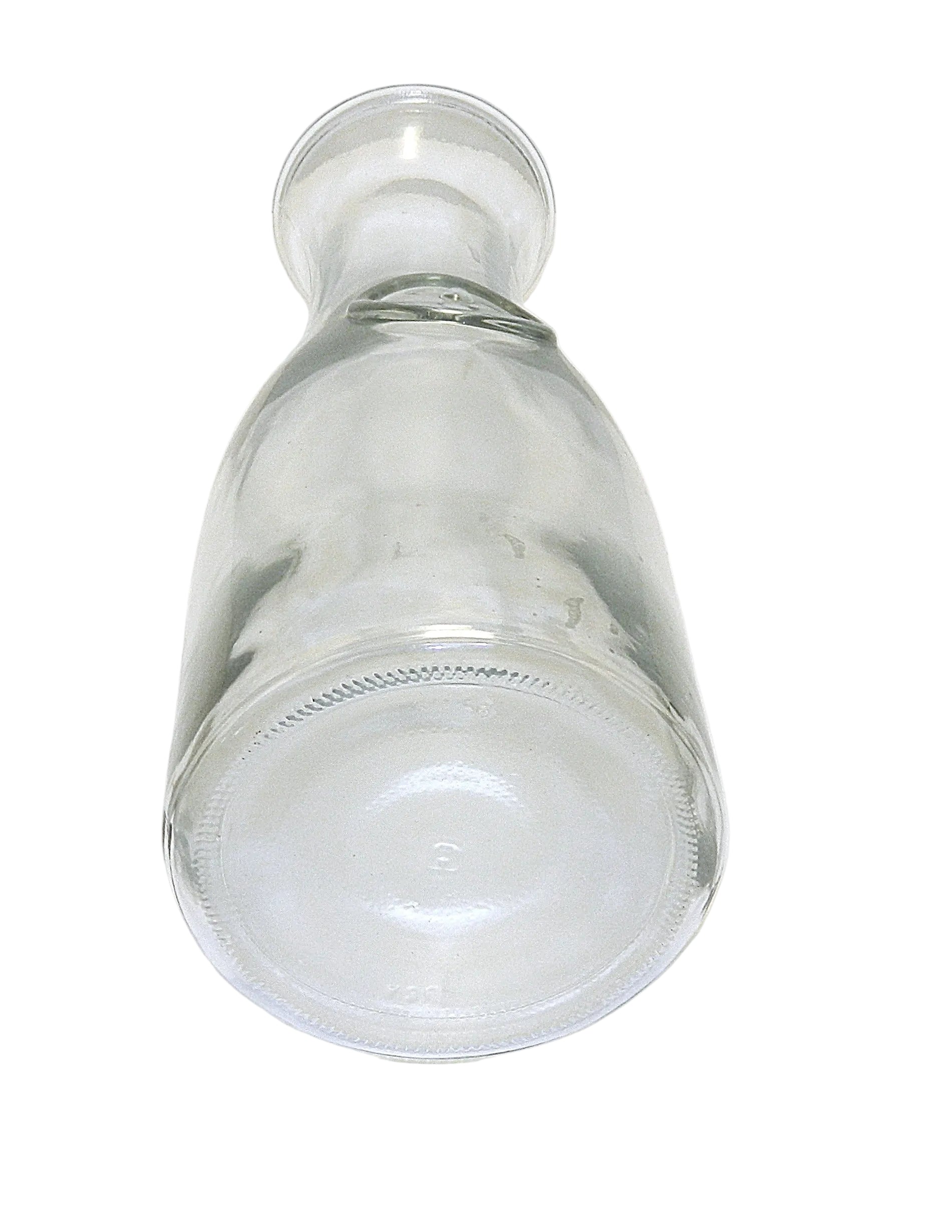 A clear glass bottle or decanter with a wide base and narrow neck, shown upside down on a white surface with a light gray background.