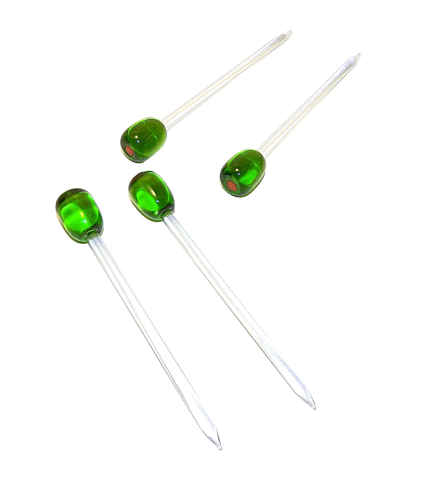 Four clear glass cocktail picks with vibrant green oval-shaped heads, arranged diagonally on a plain white background.