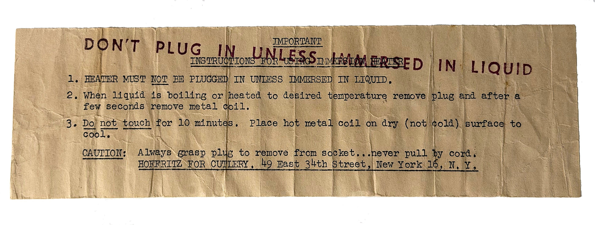 A vintage paper instruction sheet with stamped red text and handwritten blue ink notes, detailing how to properly plug and immerse a heating coil in liquid.