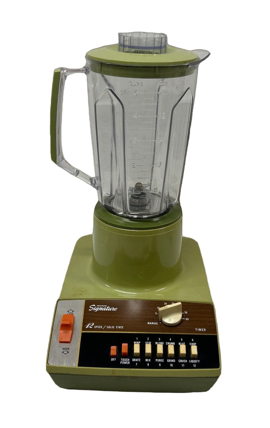 Green blender on a table with a white  background